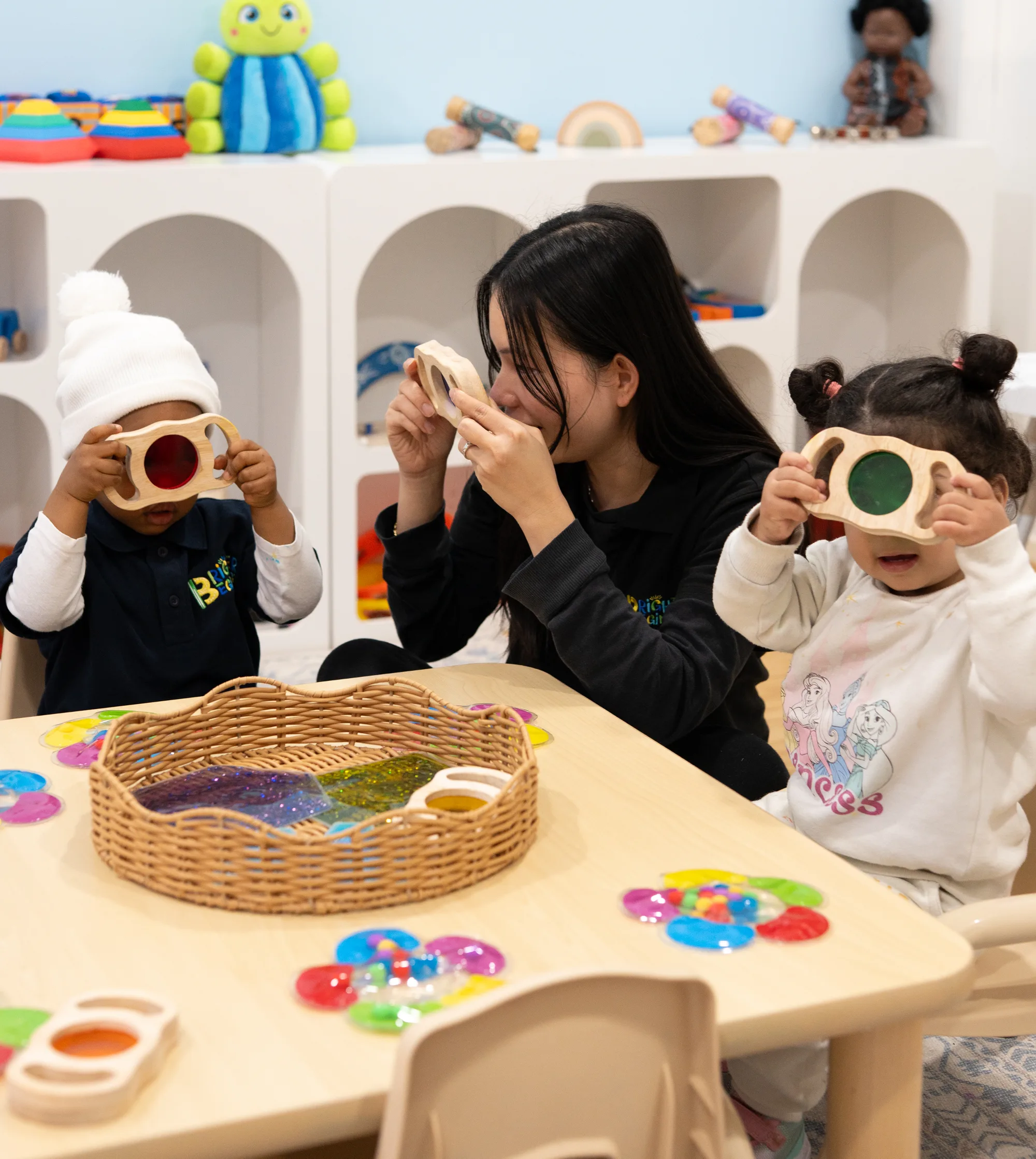 An educator settling a child in the Baby Room at Fairfield
